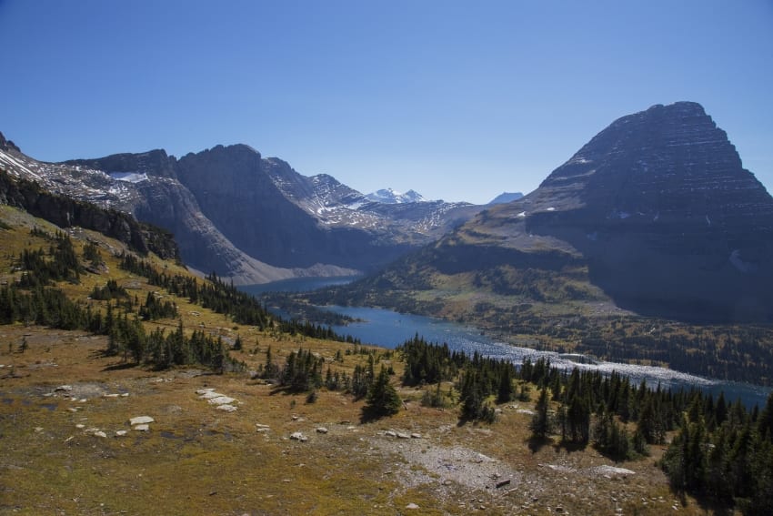 places and activities majestic natural scene with mountains and a river in the surrounding area